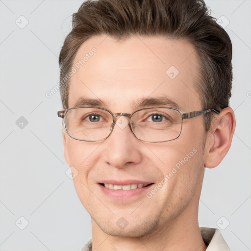 Joyful white adult male with short  brown hair and brown eyes