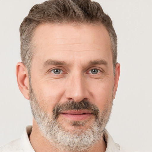 Joyful white adult male with short  brown hair and grey eyes