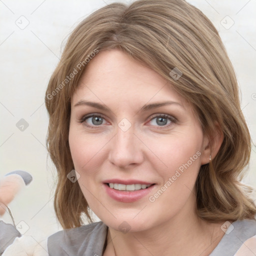 Joyful white young-adult female with medium  brown hair and blue eyes