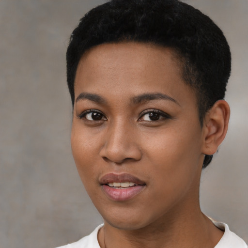 Joyful black young-adult female with short  black hair and brown eyes
