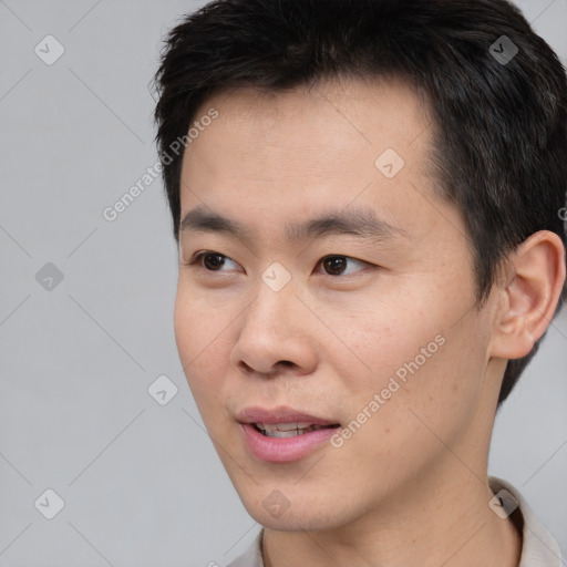 Joyful white young-adult male with short  black hair and brown eyes