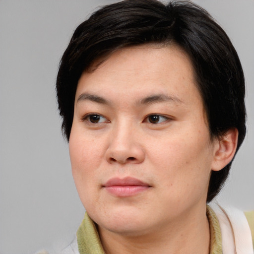 Joyful asian young-adult female with short  brown hair and brown eyes