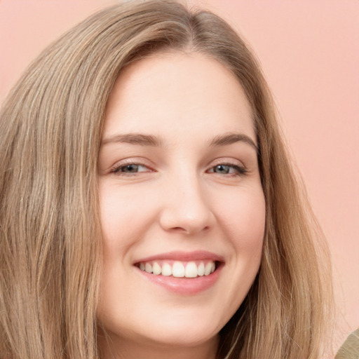 Joyful white young-adult female with long  brown hair and green eyes