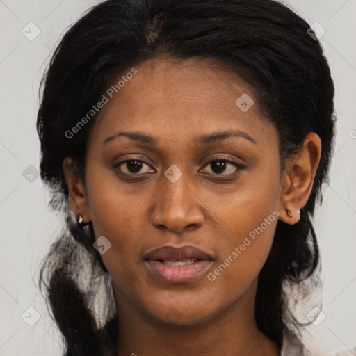 Joyful black young-adult female with long  black hair and brown eyes