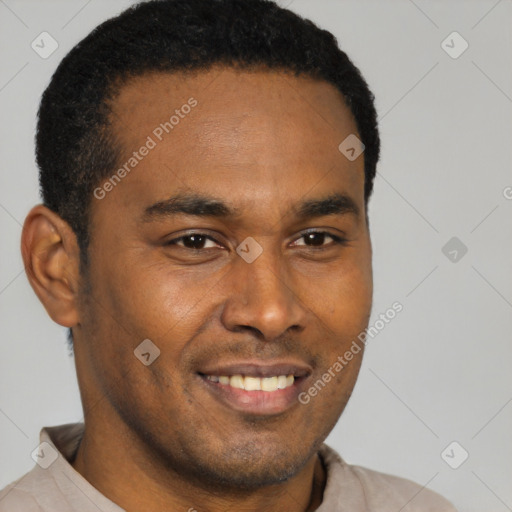 Joyful latino young-adult male with short  brown hair and brown eyes