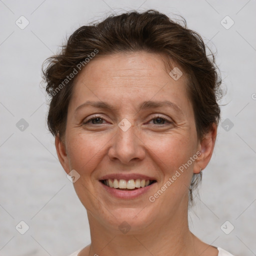 Joyful white adult female with short  brown hair and brown eyes