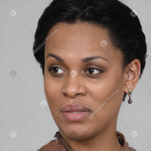 Joyful black young-adult female with short  black hair and brown eyes