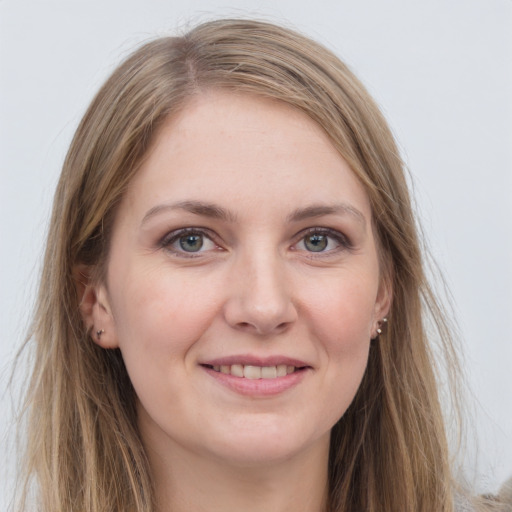 Joyful white young-adult female with long  brown hair and grey eyes