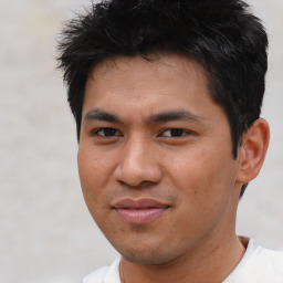 Joyful asian young-adult male with short  black hair and brown eyes