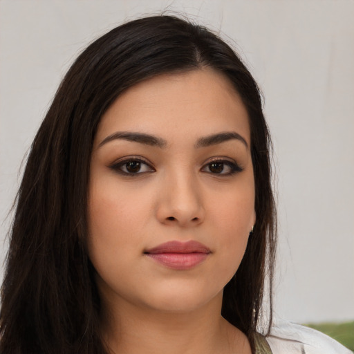 Joyful latino young-adult female with long  brown hair and brown eyes