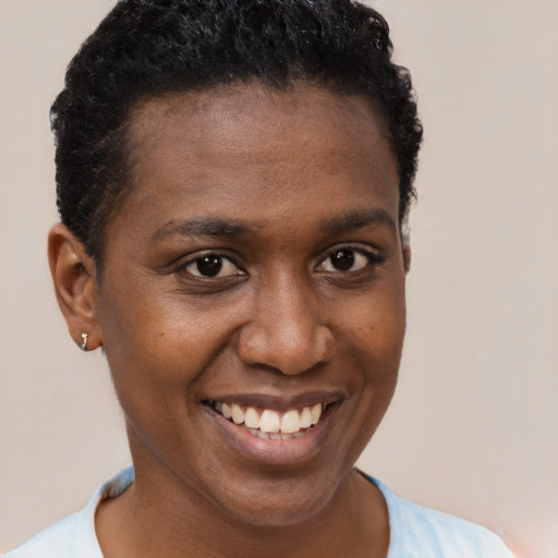 Joyful black young-adult female with short  brown hair and brown eyes