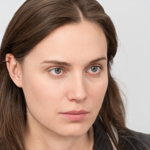 Neutral white young-adult female with long  brown hair and blue eyes