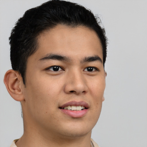 Joyful latino young-adult male with short  brown hair and brown eyes