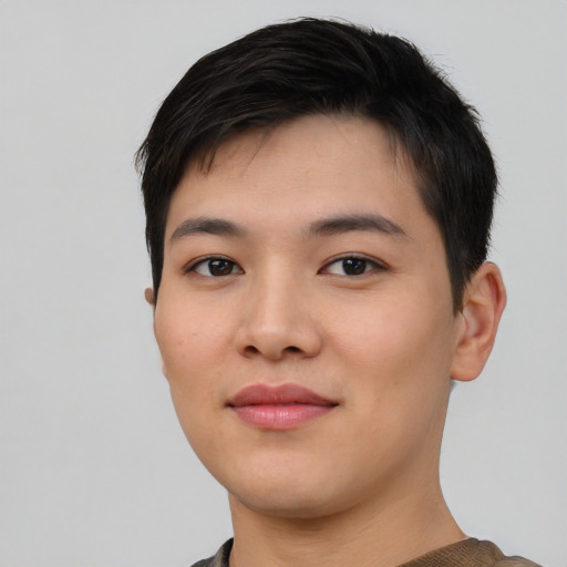 Joyful asian young-adult male with short  black hair and brown eyes