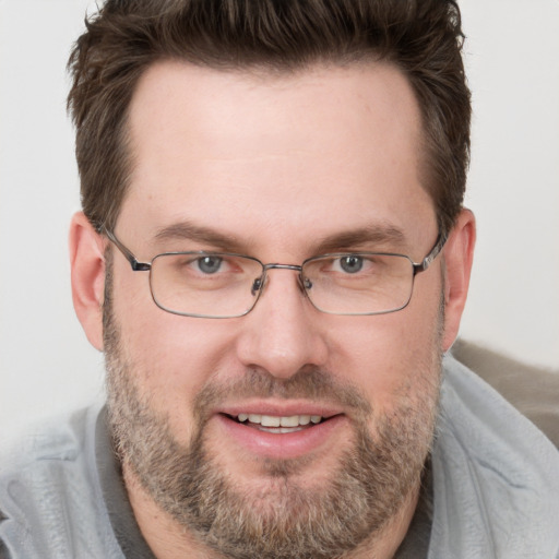 Joyful white adult male with short  brown hair and brown eyes