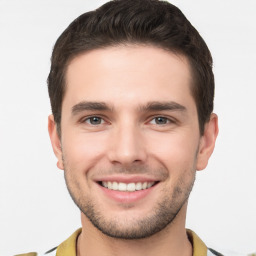 Joyful white young-adult male with short  brown hair and brown eyes