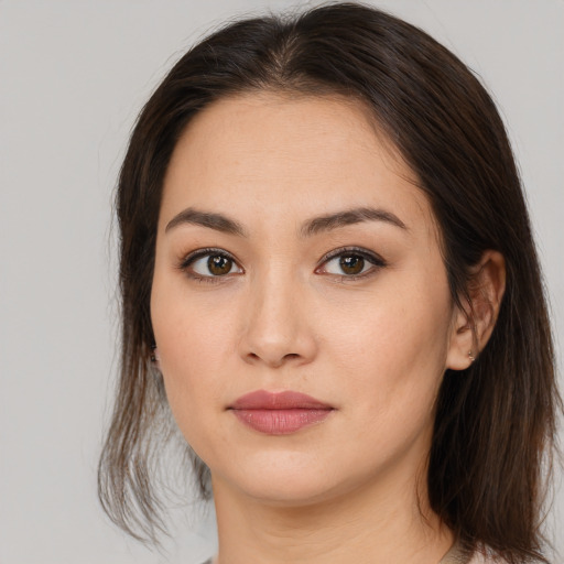 Joyful asian young-adult female with medium  brown hair and brown eyes