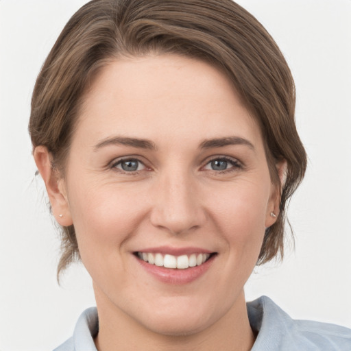 Joyful white young-adult female with medium  brown hair and grey eyes