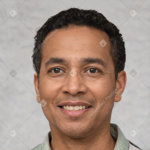 Joyful latino adult male with short  black hair and brown eyes