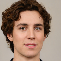 Joyful white young-adult male with medium  brown hair and brown eyes