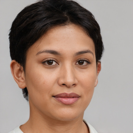 Joyful latino young-adult female with short  brown hair and brown eyes