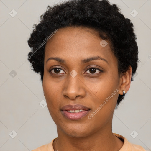 Joyful black young-adult female with short  black hair and brown eyes