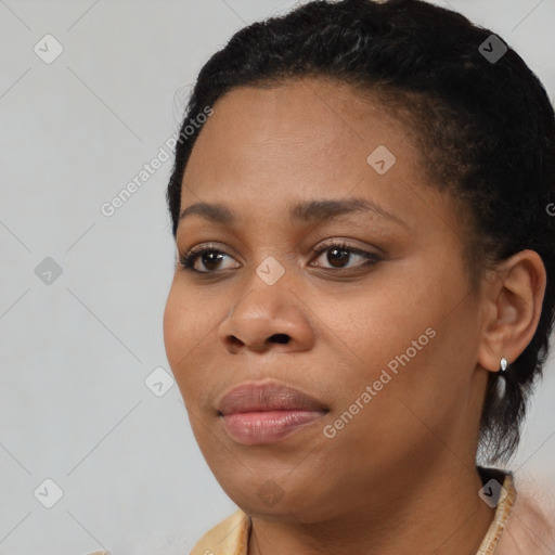 Joyful black young-adult female with short  black hair and brown eyes