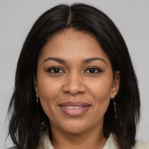 Joyful black young-adult female with medium  brown hair and brown eyes
