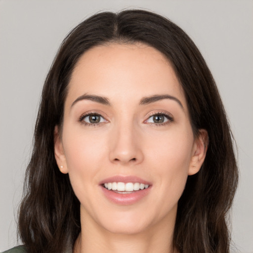 Joyful white young-adult female with long  brown hair and brown eyes