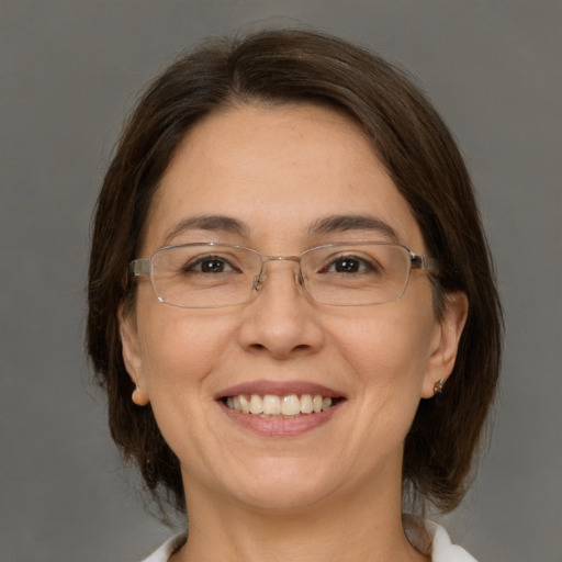 Joyful white adult female with medium  brown hair and brown eyes