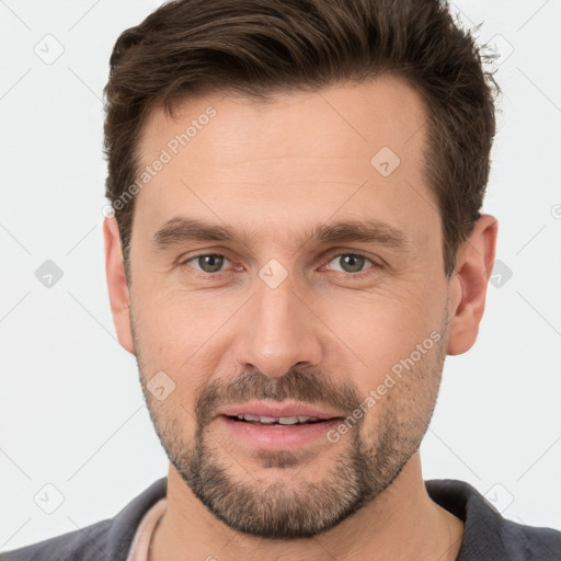 Joyful white adult male with short  brown hair and brown eyes