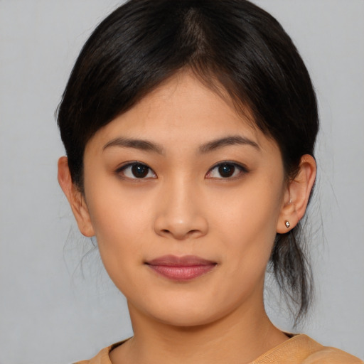 Joyful asian young-adult female with medium  brown hair and brown eyes