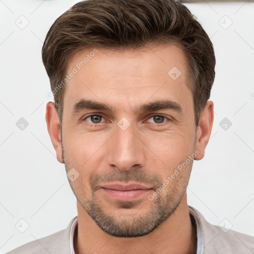 Joyful white young-adult male with short  brown hair and brown eyes