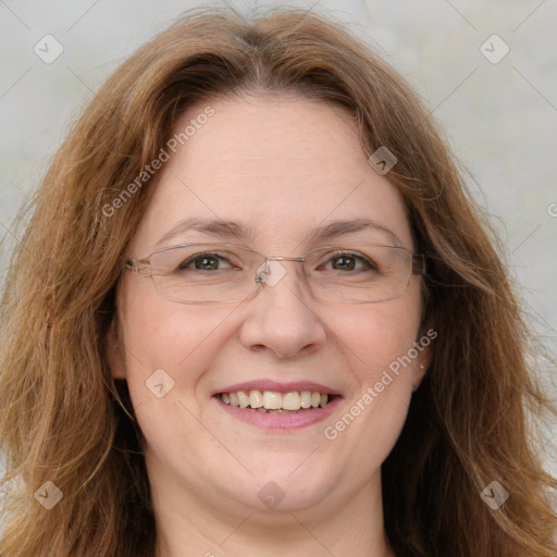 Joyful white adult female with long  brown hair and green eyes