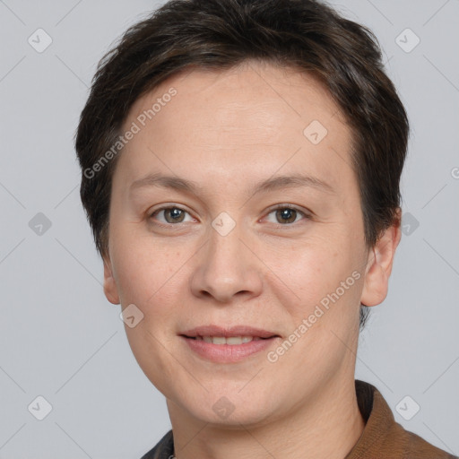 Joyful white adult female with short  brown hair and grey eyes