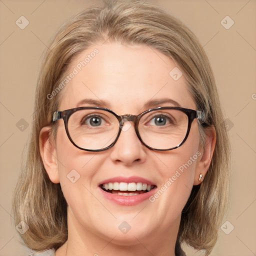 Joyful white adult female with medium  brown hair and blue eyes