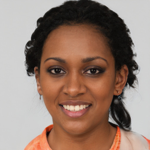 Joyful black young-adult female with medium  black hair and brown eyes