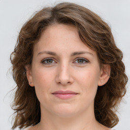 Joyful white young-adult female with medium  brown hair and green eyes