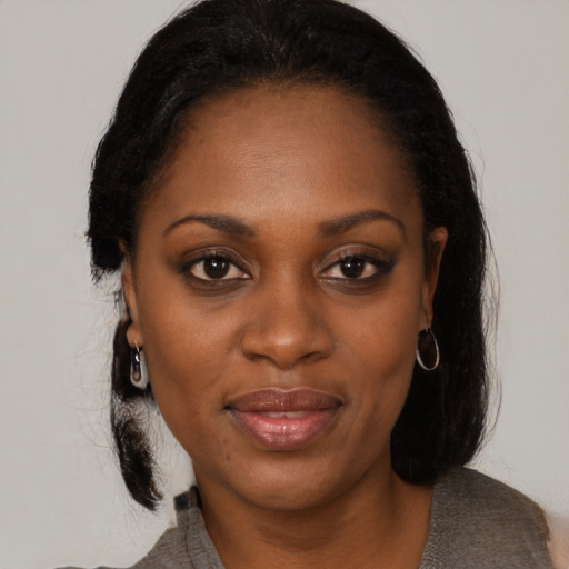 Joyful black young-adult female with medium  brown hair and brown eyes