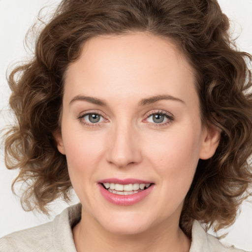 Joyful white young-adult female with medium  brown hair and green eyes