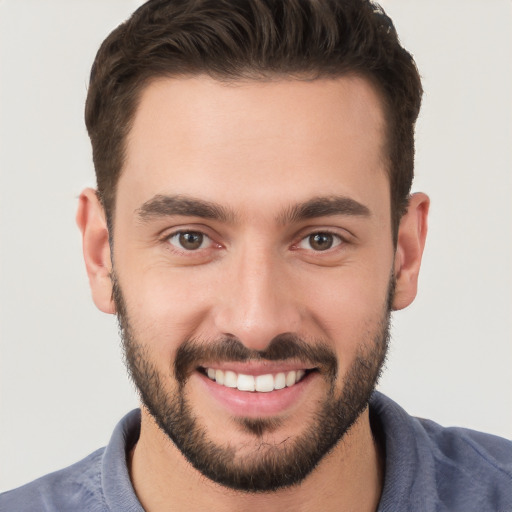 Joyful white young-adult male with short  brown hair and brown eyes