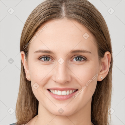 Joyful white young-adult female with long  brown hair and grey eyes