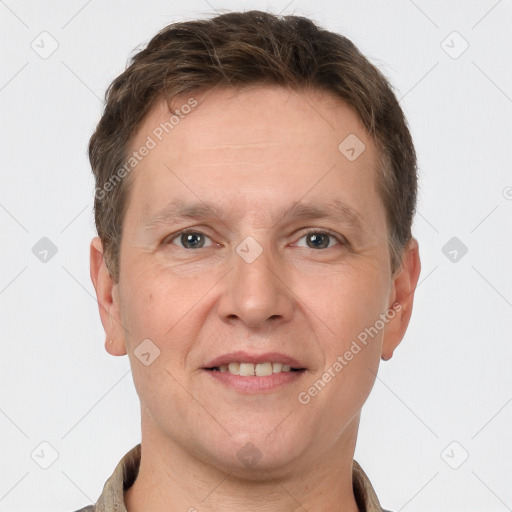 Joyful white adult male with short  brown hair and grey eyes