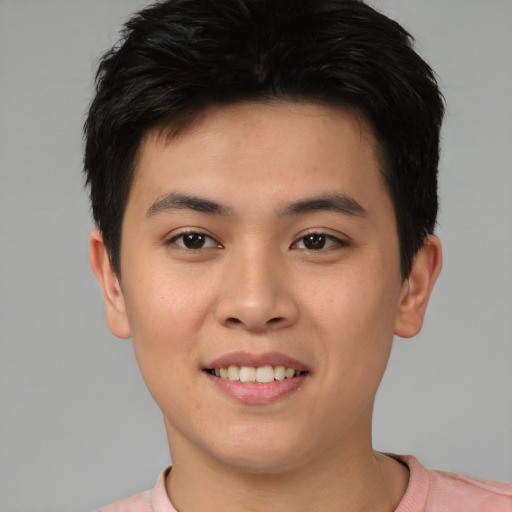Joyful asian young-adult male with short  brown hair and brown eyes
