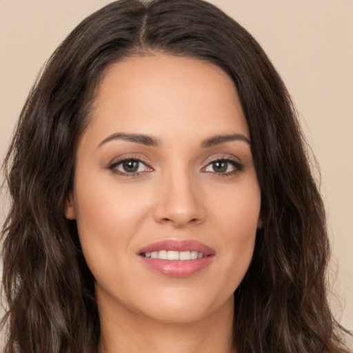 Joyful white young-adult female with long  brown hair and brown eyes