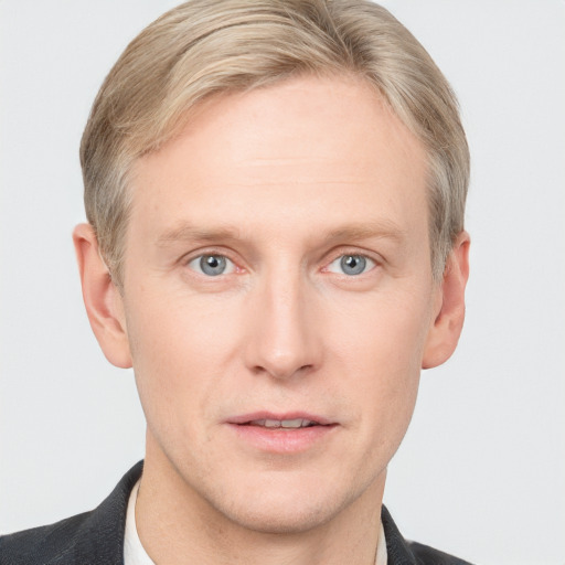 Joyful white adult male with short  brown hair and grey eyes