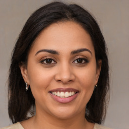 Joyful latino young-adult female with medium  brown hair and brown eyes