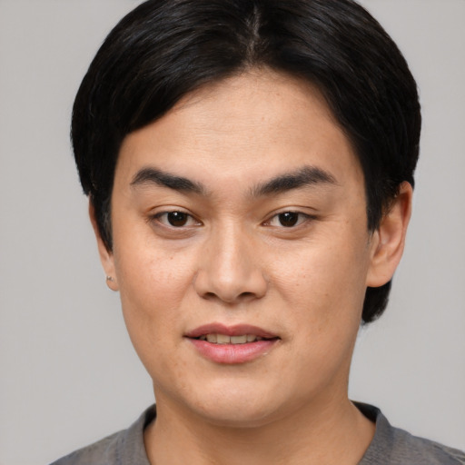 Joyful asian young-adult male with short  black hair and brown eyes