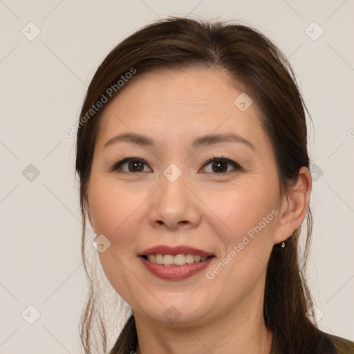 Joyful white adult female with medium  brown hair and brown eyes