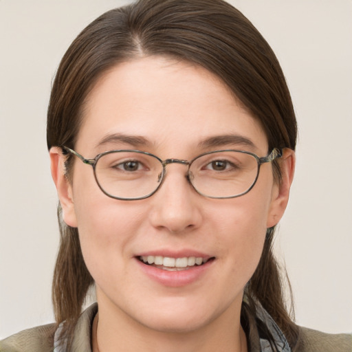 Joyful white young-adult female with medium  brown hair and brown eyes